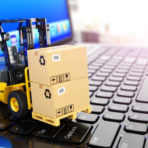 38652732 - concept of delivering, shipping or logistics. forklift on laptop keyboard. 3d
